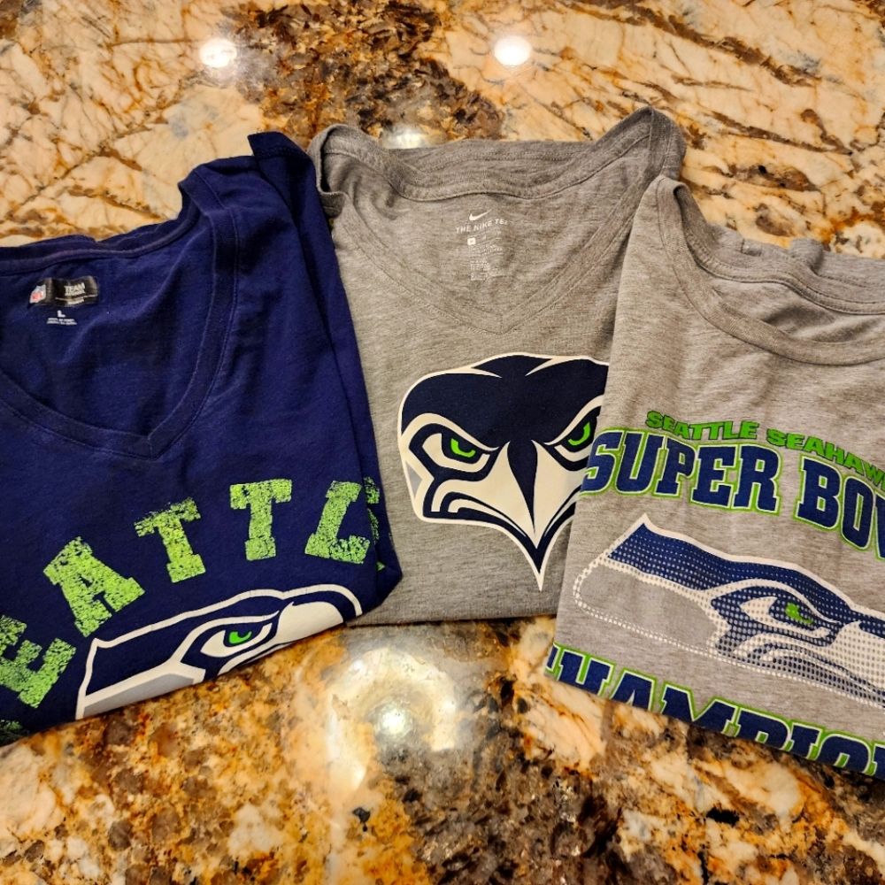 3 Seattle Seahawks t-shirts.